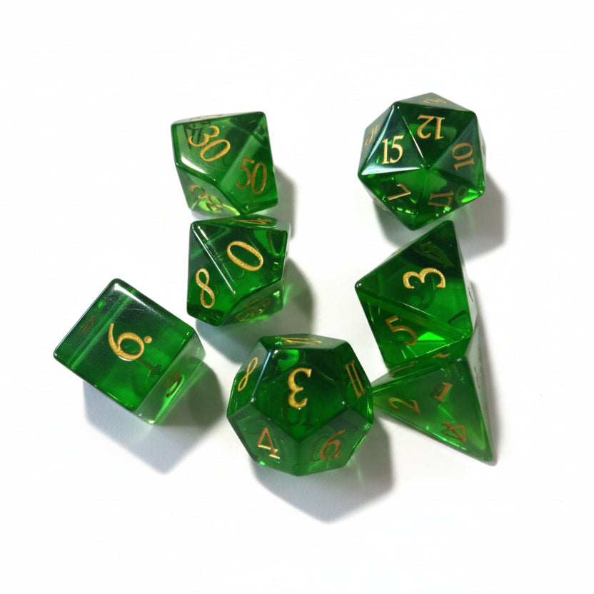 Set of green polyhedral dice with gold numbering on a white background