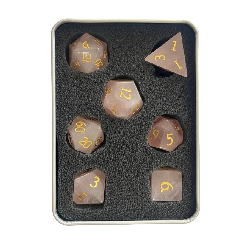 Pink quartz dice in foam container